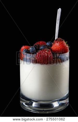 Panakota Creamy Italian Dessert In A Glass Cup With Berries And A Spoon