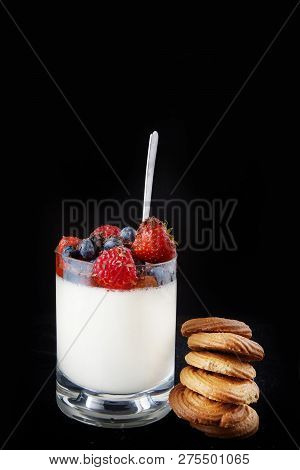 Panakota Creamy Italian Dessert In A Glass Cup With Berries And A Stack Of Ginger Cookies