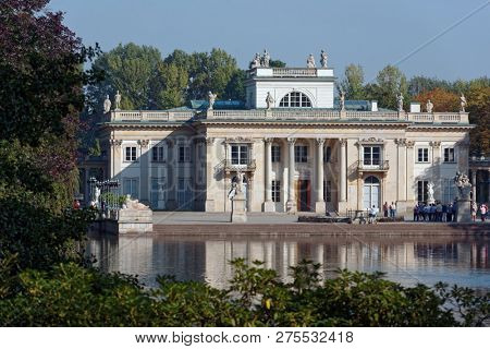 WARSAW, POLAND - SEPTEMBER 21, 2018: Tourists in front of Lazienki Palace. King Stanislaw II August remodeled the old Baroque bath house into a classicist summer residence by design of D. Merlini