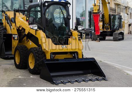 Burmarrad, Malta, 15 December 2018 - Small Lifter Yellow Excavator In The Machinery Store
