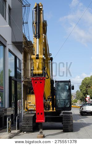 Burmarrad, Malta, 15 December 2018 - Compact Hydraulic Excavator In Front Of Machiery Store