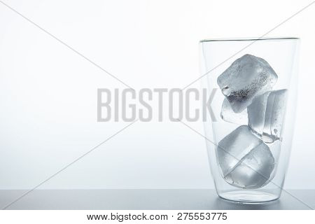 Cubes Of Ice In The Double Glass Close Up On White Background.