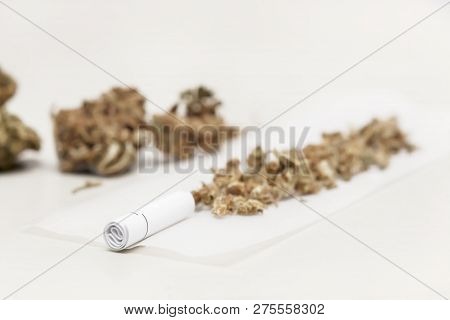 Preparing A Cannabis Joint With Tobacco And Rolling Paper With Marijuana Buds On White Background, T