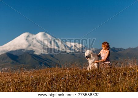 Beautiful Women And Cool White Dog Morema Sit On Grass In Mountain