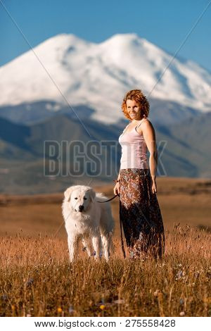Beautiful Portrait Women And Cool White Dog Morema Stay On Grass In Mountain
