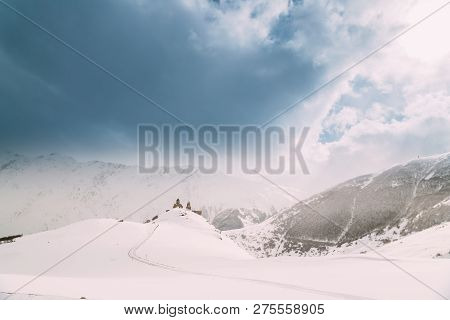 Stepantsminda, Gergeti, Georgia. Famous Ancient Gergeti Trinity Tsminda Sameba Church In Beautiful G