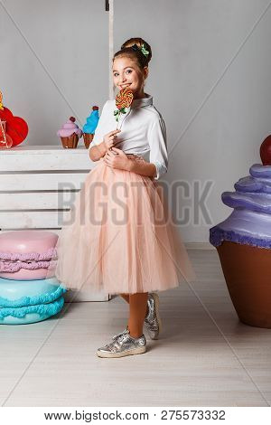 Beautiful Teenage Girls In Pink Tutu Skirts With Lollipops And Macaroons And Fansy Cakes In Studio O
