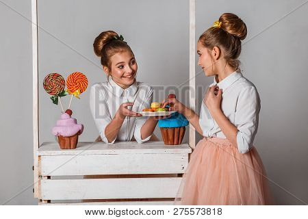 Beautiful Teenage Girls In Pink Tutu Skirts With Lollipops And Macaroons And Fansy Cakes In Studio O