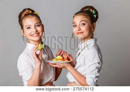 Beautiful Teenage Girls In Pink Tutu Skirts With Lollipops And Macaroons And Fansy Cakes In Studio O
