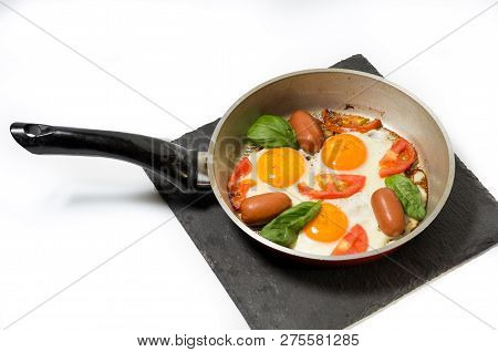 Pan with breakfast. Fresh breakfast. Fried eggs in the pan. Front view.