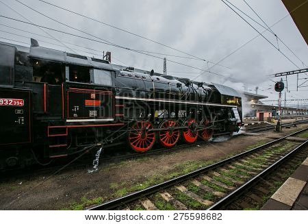 Prague, Czech Republic / Europe - December 15 2018: Old Black Steam Engine With Tender, Red Wheels, 