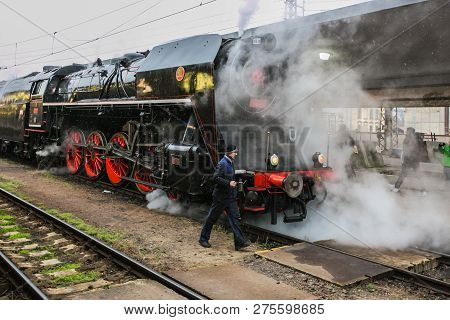 Prague, Czech Republic / Europe - December 15 2018: Old Black Steam Engine With Tender, Red Wheels, 