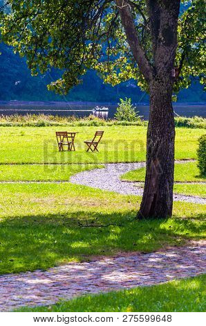 Wooden Chairs And Table On The Grass, Bent Walkways, Scenic Landscape In Nemun National Park