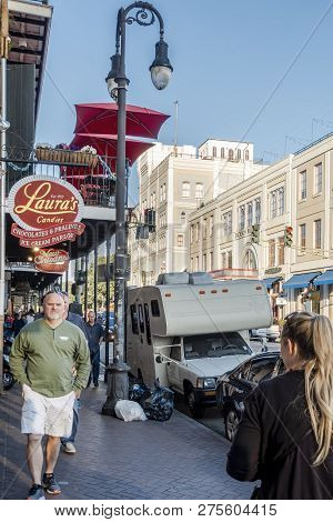New Orleans, Usa - Dec 4, 2017: Walking On The Sidewalk Outside Lauras Candies Store Along Decatur S