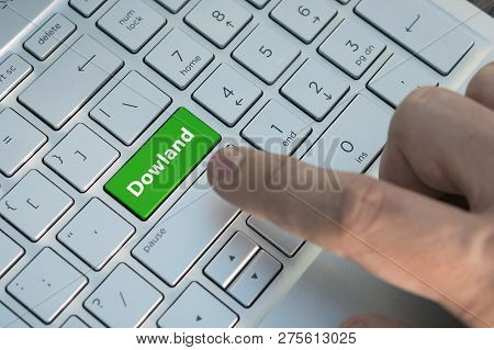 Green Download Keyboard Button Close-up. A Male Finger Presses A Color Button On A Gray Silver Keybo