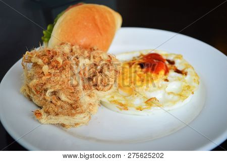 Breakfast egg fried bread Vegetable Burger and dried shredded pork on rice white plate