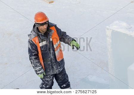 Slinger In An Orange Helmet On Unloading Ice Blocks