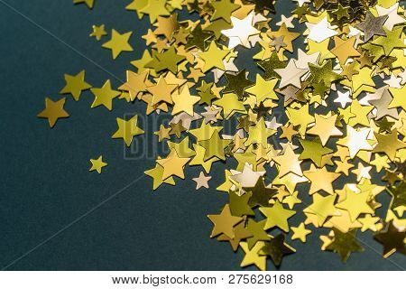 Golden Confetti Stars Scattered On The Surface.