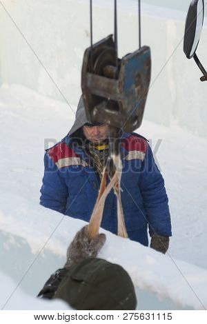 Sling Fitter In A Jacket And Helmet On The Installation Of Ice Plates