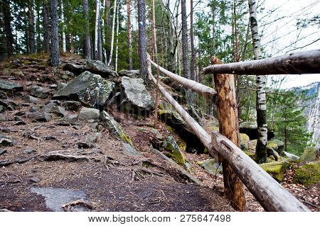Large Stones Of Rocks With Wooden Fence At Wet Forest In Carpathian Mountains.