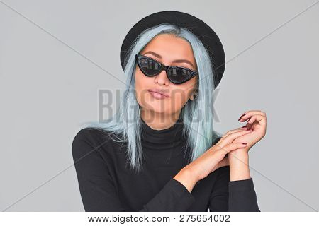 Horizontal Portrait Of Young Female With Blue Hair Posing In Studio Wearing Sunglasses. Teenager Wom