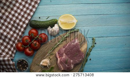 Seasoning Meat With Tomatoes Garlic Lemon Rosmary Cucamber Wooden Background
