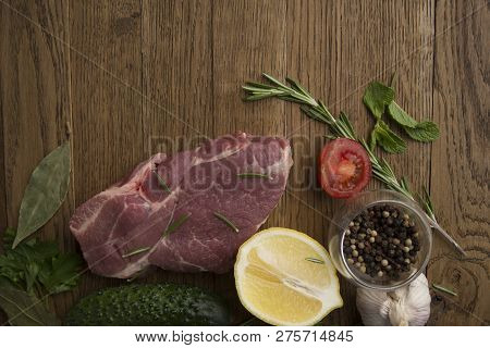 Seasoning Meat With Tomato Rosmary Cucamber Lemon Garlic Spices Wooden Background