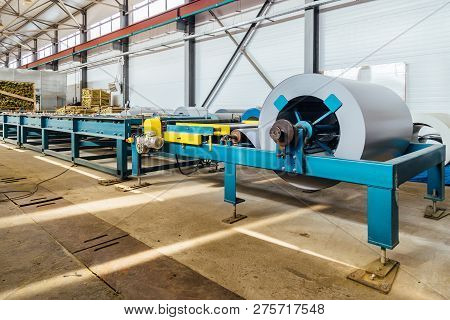 Industrial Metal Sheet Coil In Metal Sheet Profile Forming Machine In Workshop.