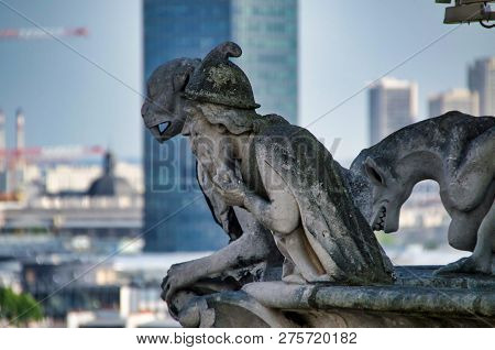 3 Gargoyles Looiking Down To The Streets Of Paris