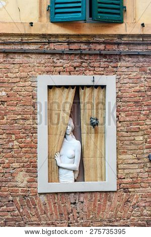 Siena, Italy - October 02, 2018: Sculpture Of Woman At The Window, Sculpture Of Woman At The Window,
