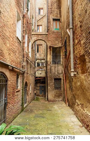 Medieval Narrow Street Vicolo Degli Orefici In Old City Siena, Tuscany, Italy.