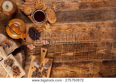 Autumn Winter Still Life. Teapot With Tea On A Wooden Table With Honey And Oatmeal Cookies And Pine