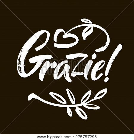 Grazie - Thank You In Italian. Calligraphy Inscription, White Word On Black Background. Handwritten 