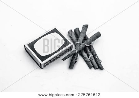 Close Up Of Mini Cigar Or Mini Cigarette Or Bidi Or Beedi Isolated On White With A Matchbox.