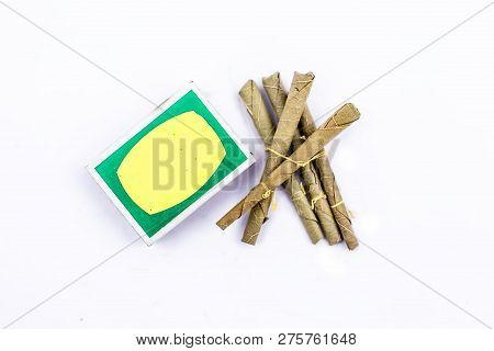 Close Up Of Mini Cigar Or Mini Cigarette Or Bidi Or Beedi Isolated On White With A Matchbox.