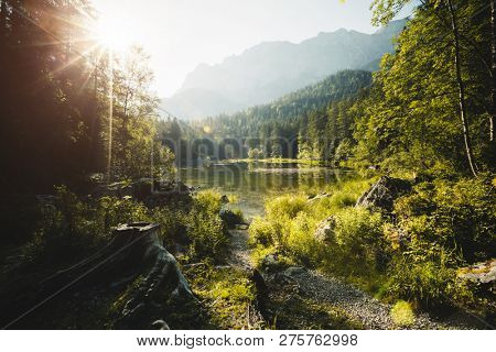 The charming mountain lake Frillensee is surrounded by coniferous forest. Location place resort Garmisch-Partenkirchen, Bavarian alps, Germany, Europe. Summer holiday. Discover the beauty of earth.