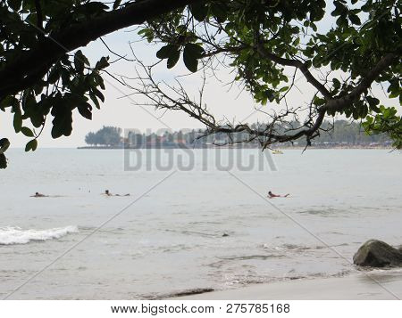 Anyer, Indonesia - June 24, 2018: Some Boys Swim On The Sea At Sambolo Beach.