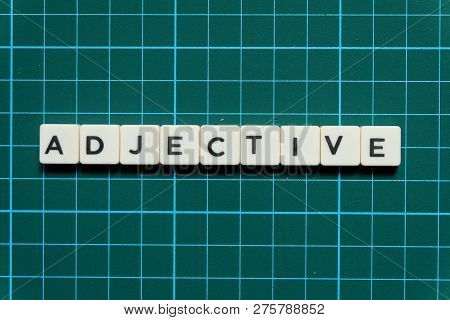 Adjective Word Made Of Square Letter Word On Green Square Mat Background.