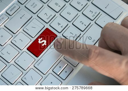 Business Man's Hand Pushing On Keyboard With Abstract Dollar Sign. A Male Finger Presses A Color But
