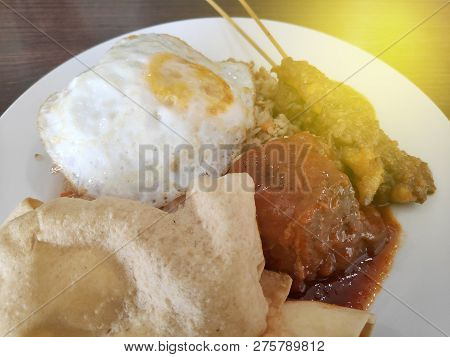 Selective Focus Of Fried Rice With Satay Egg And Papadum