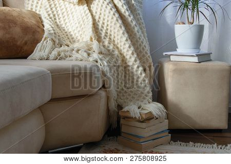 Stylish Brightly Interior Of Living Room. Inviting Comfortable Sofa With Handmade Woolen Blanket And