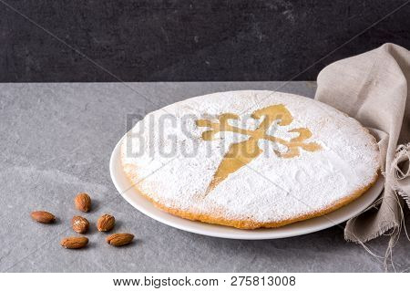 Tarta De Santiago. Traditional Almond Cake From Santiago In Spain On Gray Background