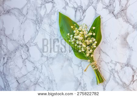 Bouquet Of Flowers Beautiful Smell Lily Of The Valley Or May-lily On Marble Background. Garden In Sp