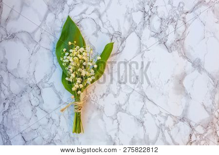 Bouquet Of Flowers Beautiful Smell Lily Of The Valley Or May-lily On Marble Background. Garden In Sp