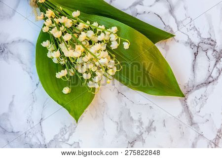 Bouquet Of Flowers Beautiful Smell Lily Of The Valley Or May-lily On Marble Background. Garden In Sp