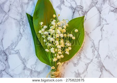 Bouquet Of Flowers Beautiful Smell Lily Of The Valley Or May-lily On Marble Background. Garden In Sp