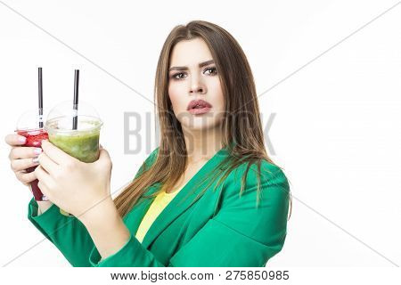 Healthy Food Eating. Choosy Thinking Woman With Both Green And Red Detox Vegetable Smoothie. Posing 
