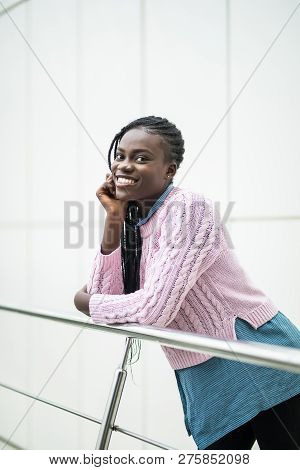 Young Pretty Afro American Woman Relaxing On Handsrails In Modern Office