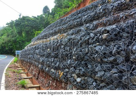 Gabion Wall Made Of Stones In The Steel Mesh, Used As A Fence On A Slope For Protection Landslide