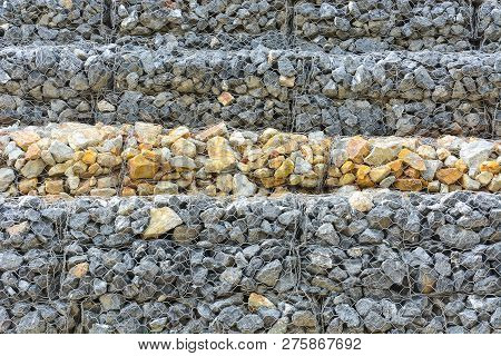 Gabion Wall Made Of Stones In The Steel Mesh, Used As A Fence On A Slope For Protection Landslide